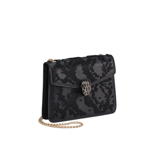 Serpenti Forever small crossbody bag in black Snake Invaders Metropolitan calf leather with a hand-sewn black glass beads embroidery and black nappa leather lining. Captivating snakehead magnetic closure in light gold-plated brass embellished with matte and shiny black enamel scales, and black onyx eyes. 292275 image 2