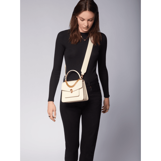 "Serpenti Forever" small maxi chain top-handle bag in black nappa leather, with black nappa leather inner lining. New Serpenti head closure in gold-plated brass, finished with small black onyx scales in the middle, and red enamel eyes. 1133-MCNb image 6
