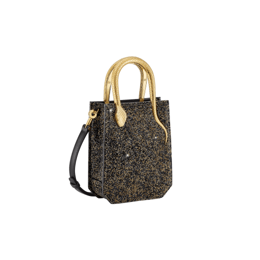 Serpentine mini tote bag in black with black crystals inserts hand-set on suede leather and black nappa leather lining. Captivating snake body-shaped handles in light gold-plated brass embellished with engraved scales and red enamel eyes. 293916 image 2