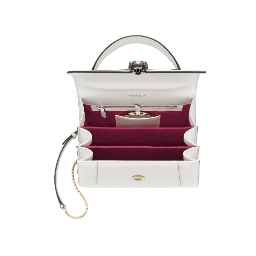 “Serpenti Forever” top handle bag in emerald green calf leather. Iconic snake head closure in light gold plated brass enhanced with black and white agate enamel and green malachite eyes. 1050-CL image 6