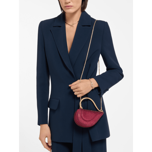 Serpenti Cuoricino mini top handle bag with gold Neige Pavé Crystals applied on a suede base and bright Travertino nappa leather lining. Captivating snake body-shaped top handle in gold-plated brass embellished with engraved scales; press-button closure. SRN-001-1366XS-CRYS image 1