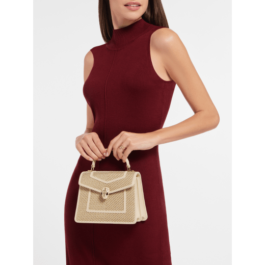 Serpenti Forever medium top handle bag in gold and ivory chévron fabric with ivory nappa leather lining. Captivating snakehead magnetic closure in light gold-plated brass embellished with ivory opal enamel and light gold-plated brass scales, and black onyx eyes. SEA-1282-W image 1