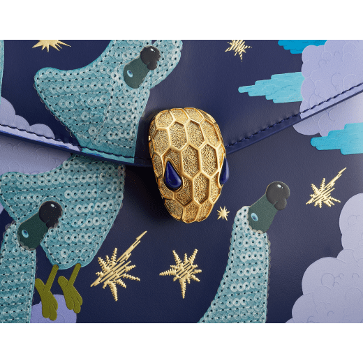 Sunwoo Kim x Bvlgari Serpenti Forever Night small top handle bag in midnight blue calf leather with nocturnal landscape print envisioned by the artist; cobalt blue calf leather sides and lavender lilac nappa leather lining. Captivating snakehead magnetic closure in gold-plated brass embellished with diamond-cut engraving on the scales, and blue lapis lazuli eyes. Limited Edition. 752-SunwooKim image 5
