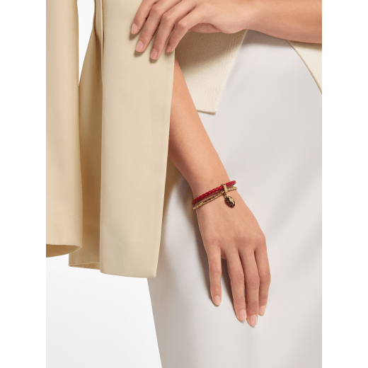 Serpenti Forever bracelet in royal ruby braided calf leather and gold-plated brass chain with magnetic clasp closure. Captivating snakehead charm embellished with black enamel, gold-plated brass scales, and black enamel eyes. SERP-BRAIDCHAIN-C image 1