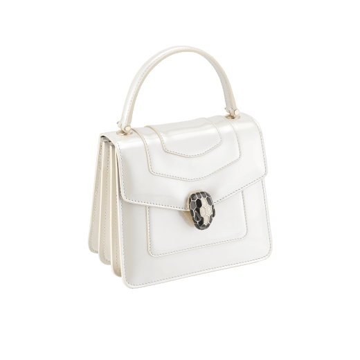 “Serpenti Forever” top-handle bag in agate-white calfskin with a polished, pearly finish and black grosgrain inner lining. Alluring snakehead closure in light gold-plated brass enriched with black and pearly, agate-white enamel and black onyx eyes 1122-VCL image 2