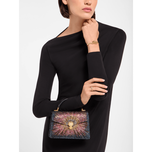 Serpenti Forever mini top handle bag in multigradient Fireworks Crystals with black nappa leather lining. Captivating snakehead magnetic closure in gold-plated brass embellished with diamond-cut engraving on the scales, and black onyx eyes. SEA-001-1283XS-fireworks image 1