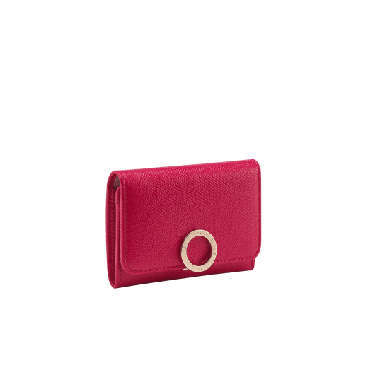 Business card holder in ruby red bright grain calf leather, desert quartz nappa and fuxia nappa lining. Iconic brass light gold plated clip featuring the BVLGARI BVLGARI motif. 579-BC-HOLDER-BGCLa image 1
