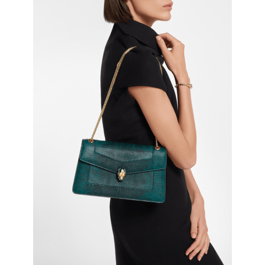 Serpenti Forever medium shoulder bag in forest emerald shiny karung with black nappa leather lining. Captivating snakehead magnetic closure in gold-plated brass embellished with forest emerald enamel and gold-plated brass scales, and black onyx eyes. 295625 image 1