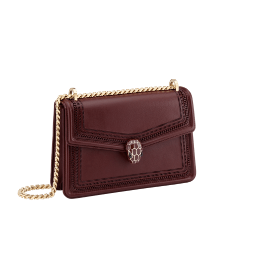 “Serpenti Diamond Blast” shoulder bag in Deep Garnet bordeuax smooth calf leather, featuring a tone-on-tone 3-Maxi Chain motif, with Deep Garnet bordeaux nappa leather internal lining. Tempting snakehead closure in light gold plated brass, enriched with Deep Garnet bordeaux enamel and black onyx eyes. 922-3MCFCL image 2