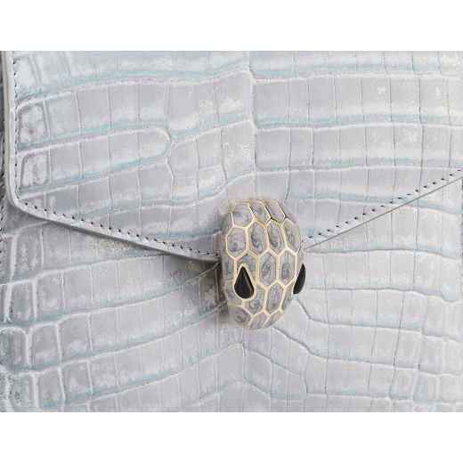 Serpenti Forever small top handle bag in white Snow Crystal crocodile skin with black nappa leather lining. Captivating snakehead press-stud closure in light gold-plated brass embellished with matt silver enamel scales and black onyx eyes. 292926 image 5