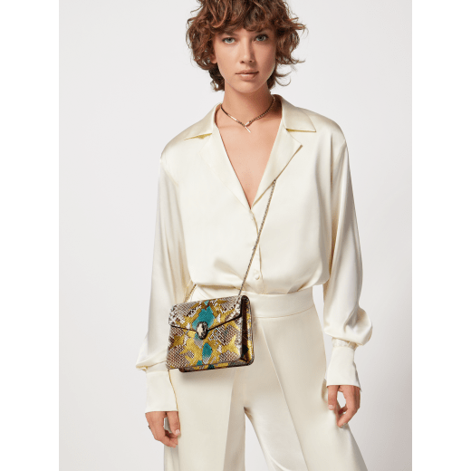 "Serpenti Forever" crossbody bag in agate-white "Camo" python skin with Mimetic Jade green nappa leather inner lining. Alluring snakehead closure in light gold-plated brass enriched with black and pearly, agate-white enamel and black onyx eyes. 422-Pa image 6