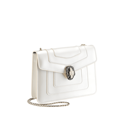 “Serpenti Forever” crossbody bag in agate-white calfskin with a polished, pearly finish and black grosgrain inner lining. Alluring snakehead closure in light gold-plated brass enriched with black and pearly, agate-white enamel and black onyx eyes 422-VCL image 2