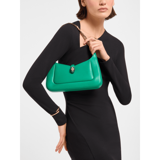 Serpenti Baia small shoulder bag in vivid emerald green Metropolitan calf leather with black nappa leather lining. Captivating snakehead magnetic closure in light gold-plated brass embellished with bright forest emerald green enamel and light gold-plated brass scales, and black onyx eyes; additional zipped top closure. SEA-1274293589 image 1