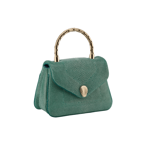 Serpenti Reverse small top handle bag in soft emerald green galuchat skin with amethyst purple nappa leather lining. Captivating magnetic snakehead closure in light gold-plated brass embellished with red enamel eyes. 1234-SG image 2