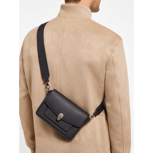 Serpenti Forever small unisex crossbody bag in matt black calf leather with black nappa leather lining and decorative chain. Captivating snakehead closure in dark ruthenium-plated brass embellished with red enamel eyes. 293022 image 2
