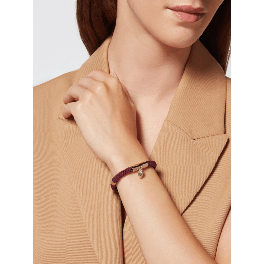 Serpenti Forever bracelet in anemone spinel pinkish red woven fabric. Captivating snakehead charm in light gold-plated brass embellished with red enamel eyes, and press-button closure. SERPMULTISTRING-WF-AS image 1
