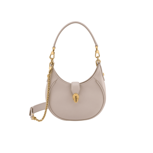 Serpenti Ellipse small crossbody bag in Urban grain and smooth flamingo quartz pink calf leather with flamingo quartz pink gros grain lining. Captivating snakehead closure in gold-plated brass embellished with black onyx scales and red enamel eyes. Online exclusive colour. 1204-UCLa image 1