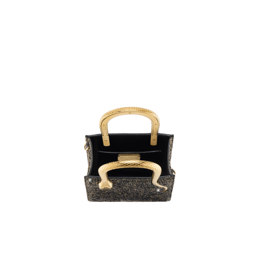 Serpentine mini tote bag in black with black crystals inserts hand-set on suede leather and black nappa leather lining. Captivating snake body-shaped handles in light gold-plated brass embellished with engraved scales and red enamel eyes. 293916 image 4