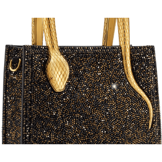 Serpentine mini tote bag in black with black crystals inserts hand-set on suede leather and black nappa leather lining. Captivating snake body-shaped handles in light gold-plated brass embellished with engraved scales and red enamel eyes. 293916 image 5