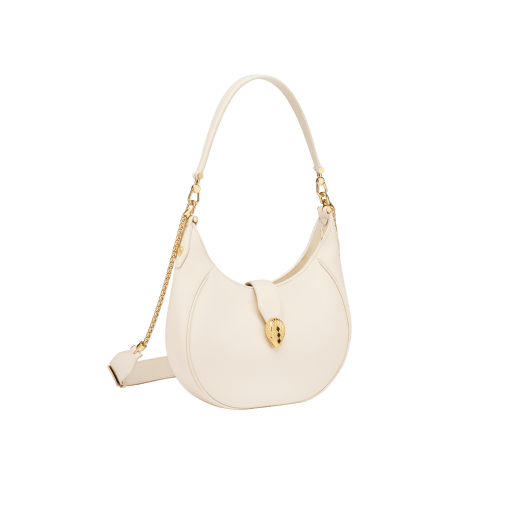Serpenti Ellipse medium shoulder bag in Urban grain and smooth ivory opal calf leather with flamingo quartz pink grosgrain lining. Captivating snakehead closure in gold-plated brass embellished with black onyx scales and red enamel eyes. 1190-UCL image 3