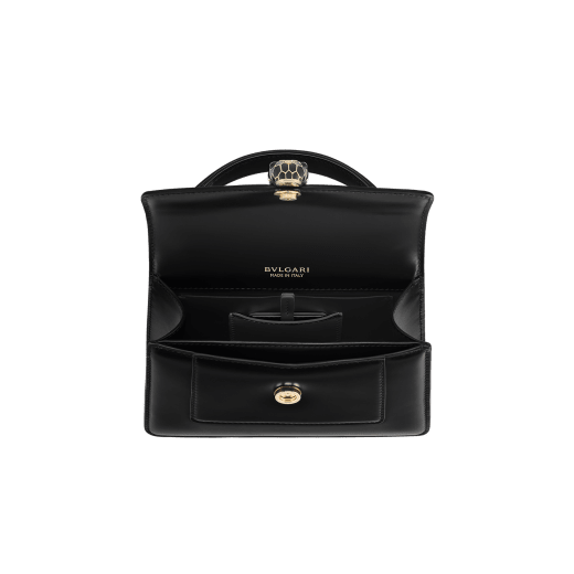 Serpenti Forever mini top handle bag in black calf leather with black nappa leather lining. Captivating snakehead magnetic closure in light gold-plated brass embellished with black enamel and light gold-plated brass scales, and black onyx eyes. SEA-1283-CL image 4