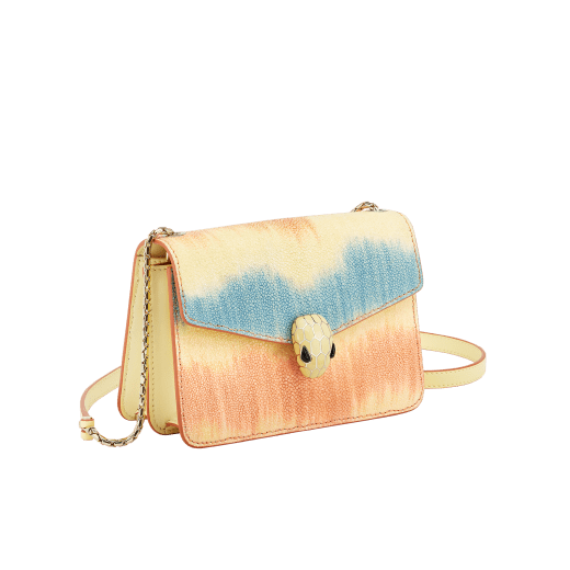 “Serpenti Forever” crossbody bag in daisy topaz full galuchat skin body and daisy topaz calf leather sides. Iconic snakehead closure in light gold plated brass enriched with black and white enamel and black onyx eyes. 1093-G image 2