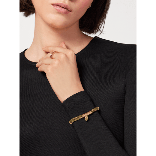 Serpenti Forever multibraided bracelet in gold coiled torchon and light-gold plated brass chain. Captivating snakehead charm in light gold-plated brass embellished with red enamel eyes, and press-stud closure. SERPMULTIBRAID-WC-G image 1