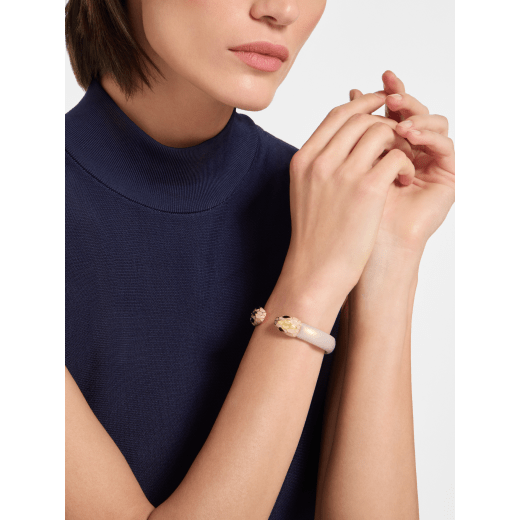 Serpenti Forever bangle bracelet in gold-finished brass with rose gold space lamb leather inserts. Captivating contraire snakehead motif in gold-finished brass embellished with rose gold enamel, gold-finished brass scales and black enamel eyes. BRACLT-SP-CONTR-spacelamb image 1