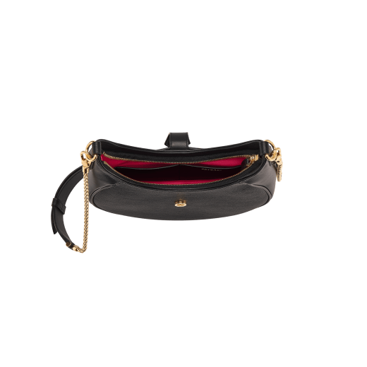 Serpenti Ellipse medium shoulder bag in Urban grain and smooth Niagara sapphire blue calf leather with cloud topaz blue grosgrain lining. Captivating snakehead closure in gold-plated brass embellished with black onyx scales and red enamel eyes. 1190-UCL image 7