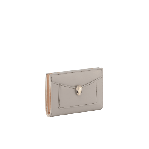 Serpenti Forever folded card holder in light gold Striated calf leather with linen agate nappa leather interior. Captivating snakehead décor in light gold-plated brass embellished with champagne enamel and light gold-plated brass scales, and black enamel eyes; press-button closure. SEA-CC-HOLD-FOLD-R image 1