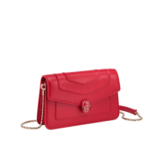 Serpenti Forever chain wallet in amaranth garnet red calf leather and flamingo quartz pink nappa leather interior. Captivating light gold-plated brass snakehead magnetic closure embellished with matt and shiny amaranth garnet red enamel scales and black onyx eyes. SEA-CHAINPOCHETTE-LCL image 1