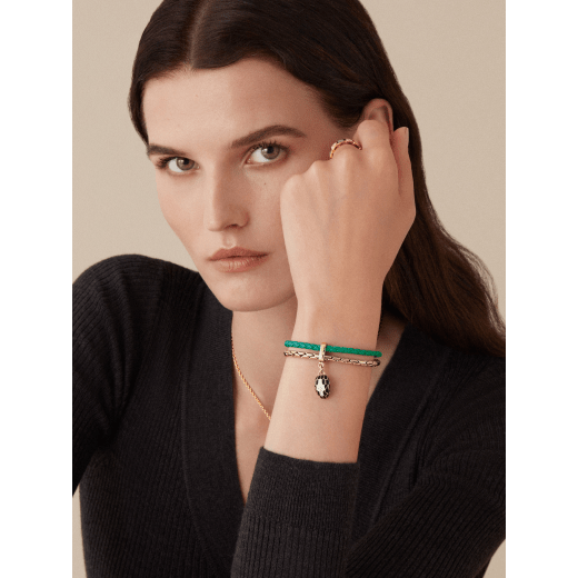 "Serpenti Forever" bracelet in braided, emerald-green calfskin with snake body-shaped chain in light gold-plated brass, iconic snakehead charm in black and agate-white enamel, black enamel eyes and magnetic clasp fastening. SerpBraidChain-WCL-EG image 2