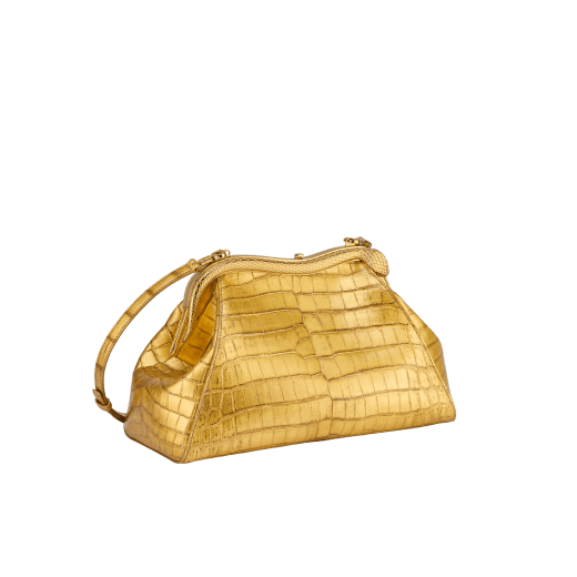 Serpentine medium pouch in antique gold soft metallic crocodile skin with 24 kt gold treatment and emerald green nappa leather lining. Captivating snake-shaped frame in gold-plated brass including 3 µ of 24 kt gold, embellished with engraved scales and red enamel eyes on one side and antique gold soft metallic crocodile insert on the other, and press-button closure. Exclusive Bulgari 50th anniversary in the US Edition. 292590 image 2
