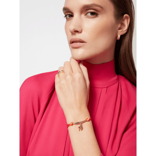 Serpenti Forever Special Resort Edition bracelet in coral carnelian orange fabric. Light gold-plated brass tubular element, captivating snakehead charm embellished with red enamel eyes and palm charm. SERP-PALM-STRING image 1