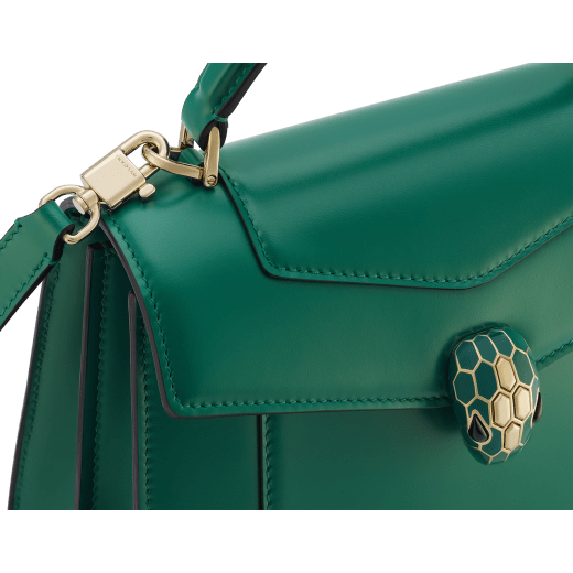 Serpenti Forever medium top handle bag in emerald green calf leather with black nappa leather lining. Captivating snakehead magnetic closure in light gold-plated brass embellished with deep jade intense green enamel and light gold-plated brass scales, and black onyx eyes. SEA-1282-CL image 5