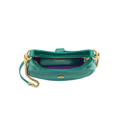 Serpenti Ellipse small crossbody bag in Urban grain and smooth ivory opal calf leather with flamingo quartz pink grosgrain lining. Captivating snakehead closure in gold-plated brass embellished with black onyx scales and red enamel eyes. 1204-UCL image 4