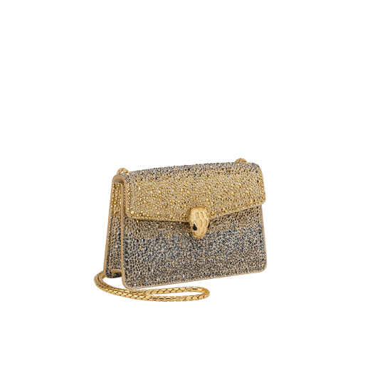 Serpenti Forever mini crossbody bag in natural suede with different-size gold crystals and black nappa leather lining. Captivating magnetic snakehead closure in gold-plated brass embellished with "diamantatura" engraving on the scales and black onyx eyes. 986-CDS image 2