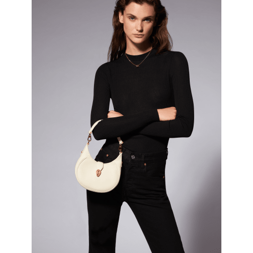 Serpenti Ellipse small crossbody bag in Urban grain and smooth ivory opal calf leather with flamingo quartz pink gros grain lining. Captivating snakehead closure in gold-plated brass embellished with black onyx scales and red enamel eyes. 1204-UCL image 11