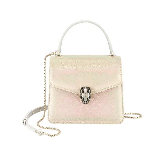 “Serpenti Forever” crossbody bag in Milky Opal beige galuchat skin with agate-white calfskin edges and black nappa leather inner lining. Alluring snakehead closure in light gold-plated brass enriched with black and pearly, agate-white enamel and black onyx eyes. 752-CG image 1