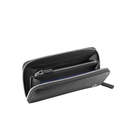 Zipped wallet in black grain calf leather with royal blue nappa lining. Brass palladium plated hardware featuring the Bvlgari-Bvlgari motif. Eight credit card slots, two internal compartments, one zipped coin case in the middle and two additional compartments. Zip-around closure. BBM-WLT-M-ZIPa image 2