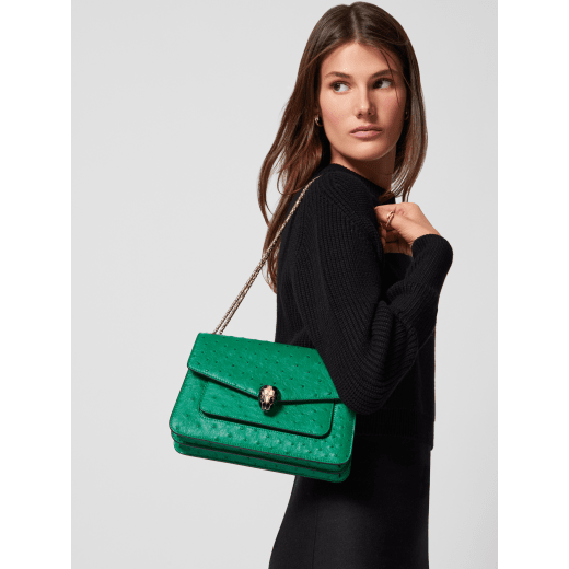 Serpenti Forever medium shoulder bag in vivid emerald green shiny ostrich skin with emerald green nappa leather lining. Captivating snakehead magnetic closure in light gold-plated brass embellished with black enamel and light gold-plated brass scales and black onyx eyes. 293263 image 1
