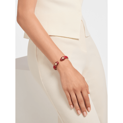 Serpenti Forever bangle bracelet in gold-plated brass with amaranth garnet pure karung inserts. Captivating contraire snakehead motif embellished with royal ruby enamel, gold-plated brass scales, and black enamel eyes. BRACLT-SP-CONTR-KAR image 1