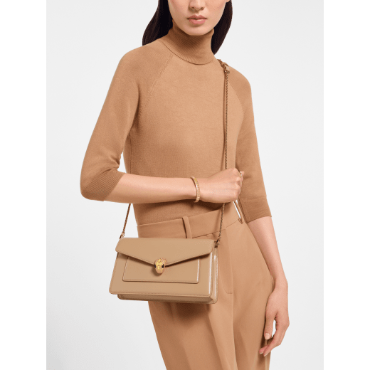 Serpenti Forever small crossbody bag in Travertine calf leather with Travertine nappa leather lining. Captivating snakehead magnetic closure in gold-plated brass embellished with beige noisette enamel and gold-plated brass scales, and black onyx eyes. 295079 image 1