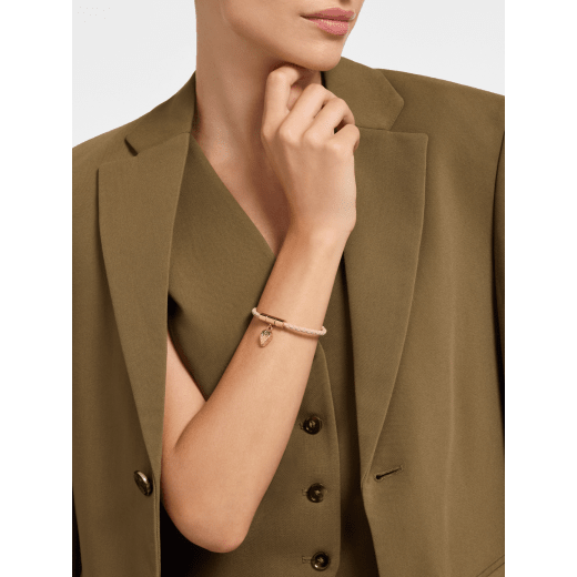 Serpenti Forever braided bracelet in star rose pink calf leather. Gold-plated brass captivating snakehead charm attached on the frontal clasp closure. SERP-HERBRAID-WCL-E image 1