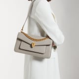 Serpenti East-West Maxi Chain medium shoulder bag in foggy opal grey Metropolitan calf leather with linen agate beige nappa leather lining. Captivating snakehead magnetic closure in gold-plated brass embellished with grey agate scales and red enamel eyes. SEA-1238-MCCL image 7