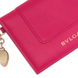 Serpenti Forever folded card holder in coral carnelian orange calf leather with flamingo quartz pink nappa leather interior. Captivating light gold-plated brass snakehead charm with red enamel eyes, and press-stud closure. SEA-CC-HOLDER-FOLD-Cla image 4