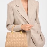 Serpentine Day Duo top handle bag in black calf leather with Calla matelassé motif and black nappa leather lining. Captivating double-head snake body-shaped handles in gold-plated brass embellished with matching calf leather inserts. SRN-001-1315M image 1