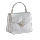 Serpenti Forever small top handle bag in white Snow Crystal crocodile skin with black nappa leather lining. Captivating snakehead press-stud closure in light gold-plated brass embellished with matte silver enamel scales and black onyx eyes. 292926 image 2