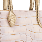 Serpentine mini tote bag in white Moonpearl alligator skin with crystal rose nappa leather lining. Captivating snake body-shaped handles in light gold-plated brass embellished with engraved scales and red enamel eyes. 293444 image 6
