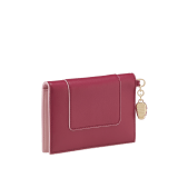 Serpenti Forever folded card holder in coral carnelian orange calf leather with flamingo quartz pink nappa leather interior. Captivating light gold-plated brass snakehead charm with red enamel eyes, and press-stud closure. SEA-CC-HOLDER-FOLD-Cla image 3